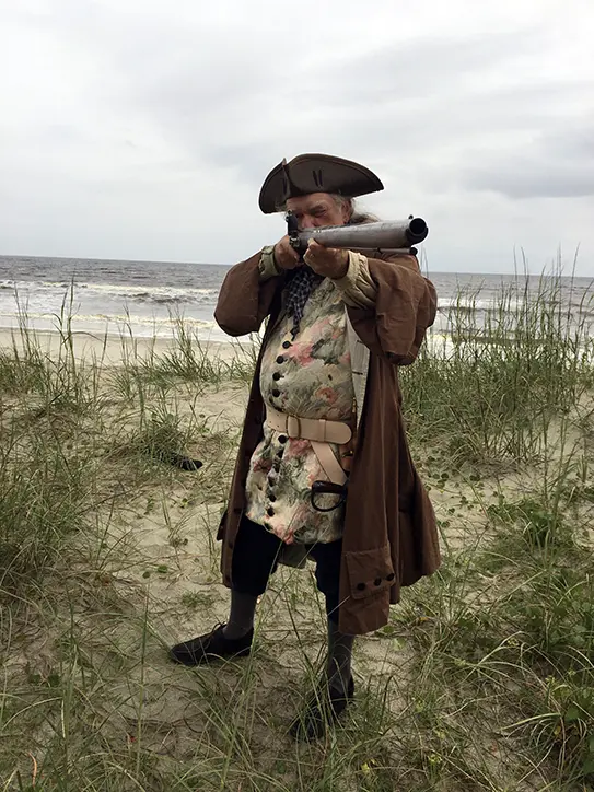 A Carolina pirate shoulders a musket