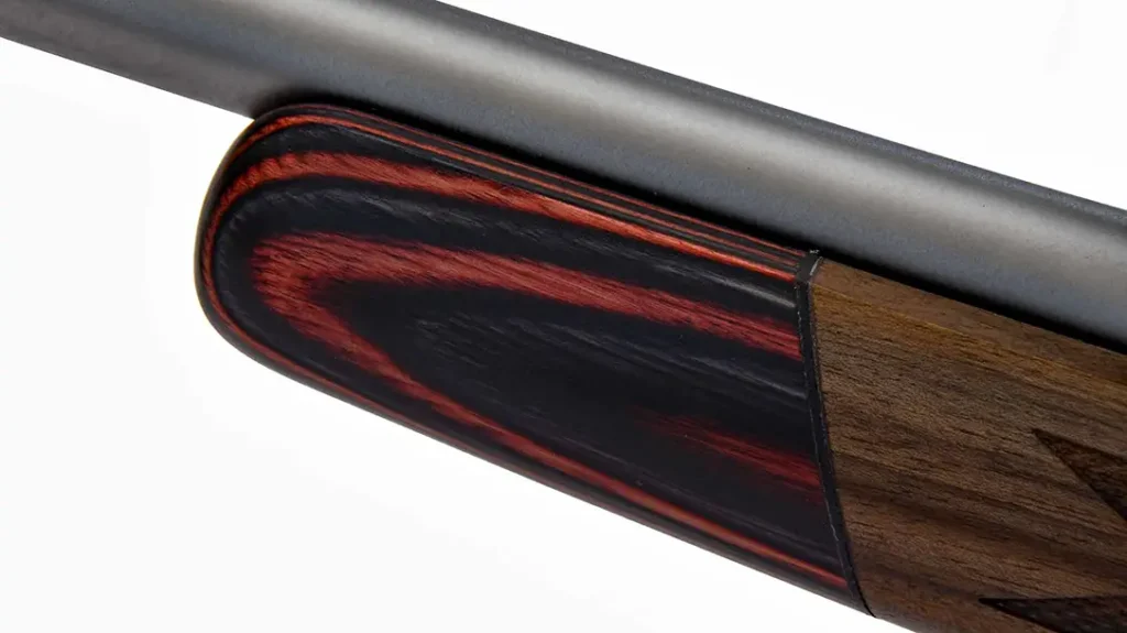 The rifle's stock features a laminated forend tip.