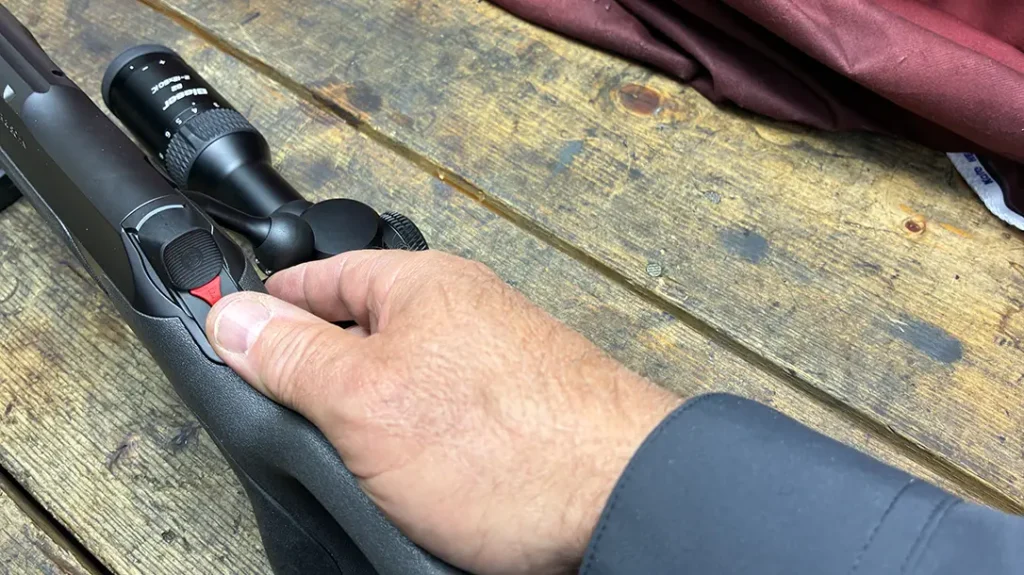 The Sauer 505 safety is not so much of a mechanical block, but rather a sliding “actuator” button that you use to cock and de-cock the rifle. It is located at the rear end of the bolt.