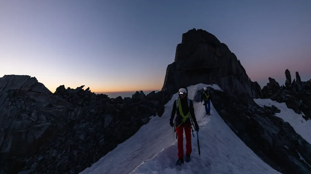 Hikers against a snowy mountain