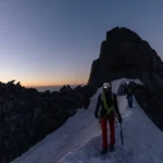 Hikers against a snowy mountain